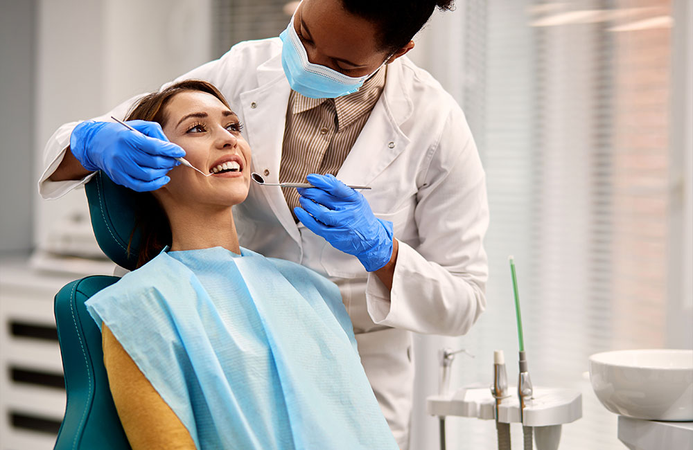 Woman receiving dental treatment from a dental assistant