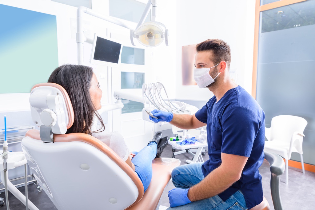 Dental assistant talking to patient during appointment