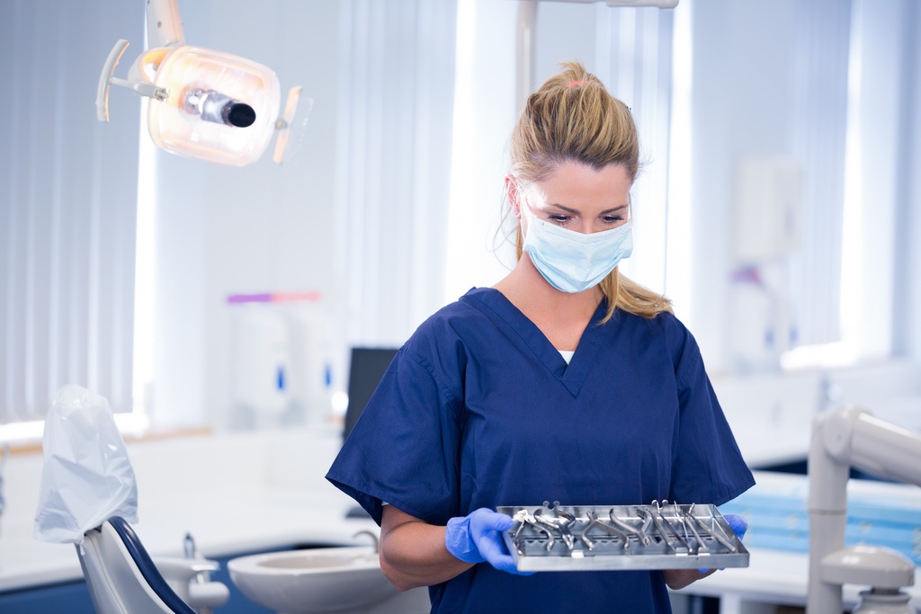 Dental assistant preparing exam room before appointment