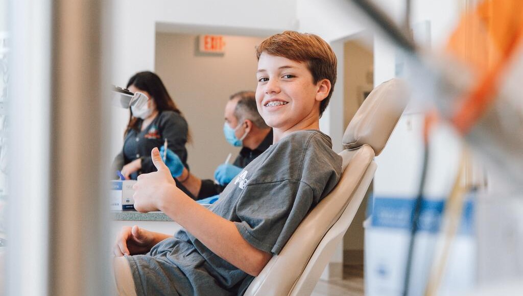 teenage boy, thumbs up, dental chair, dentist