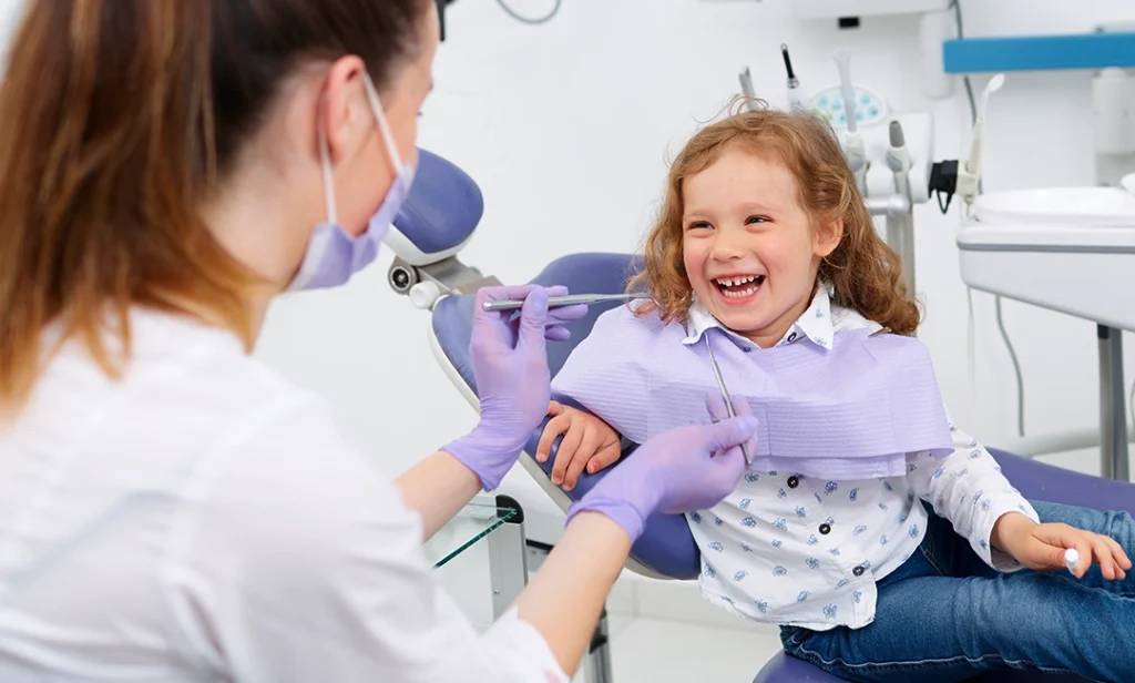 Young girl sitting in dentist chair