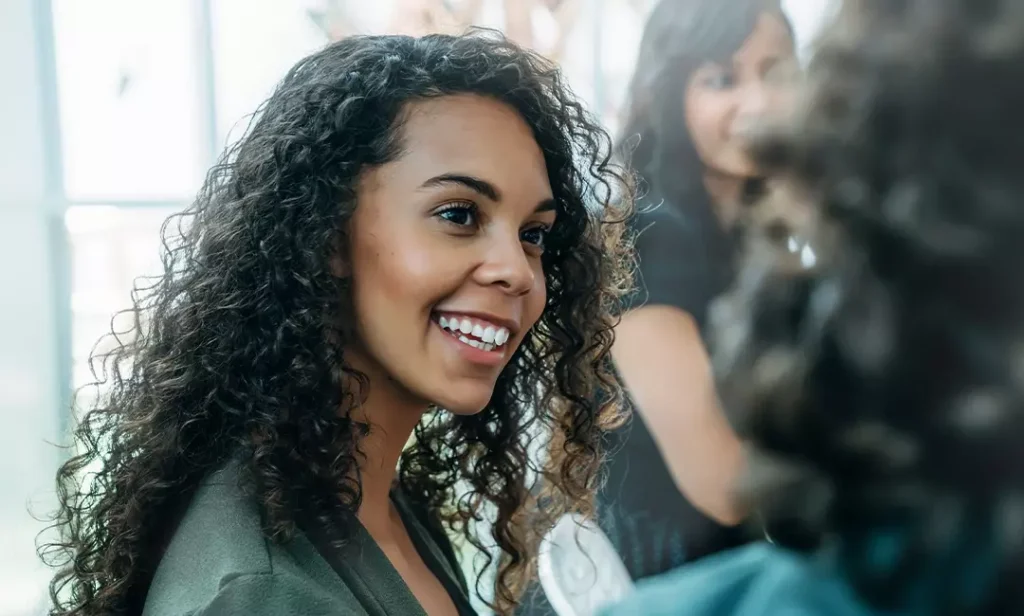 Dental assistant smiling while attending networking event