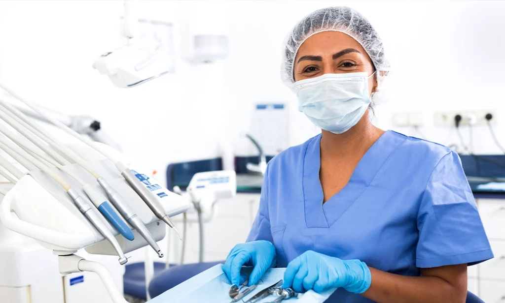 Dental assistant smiling under mask during training