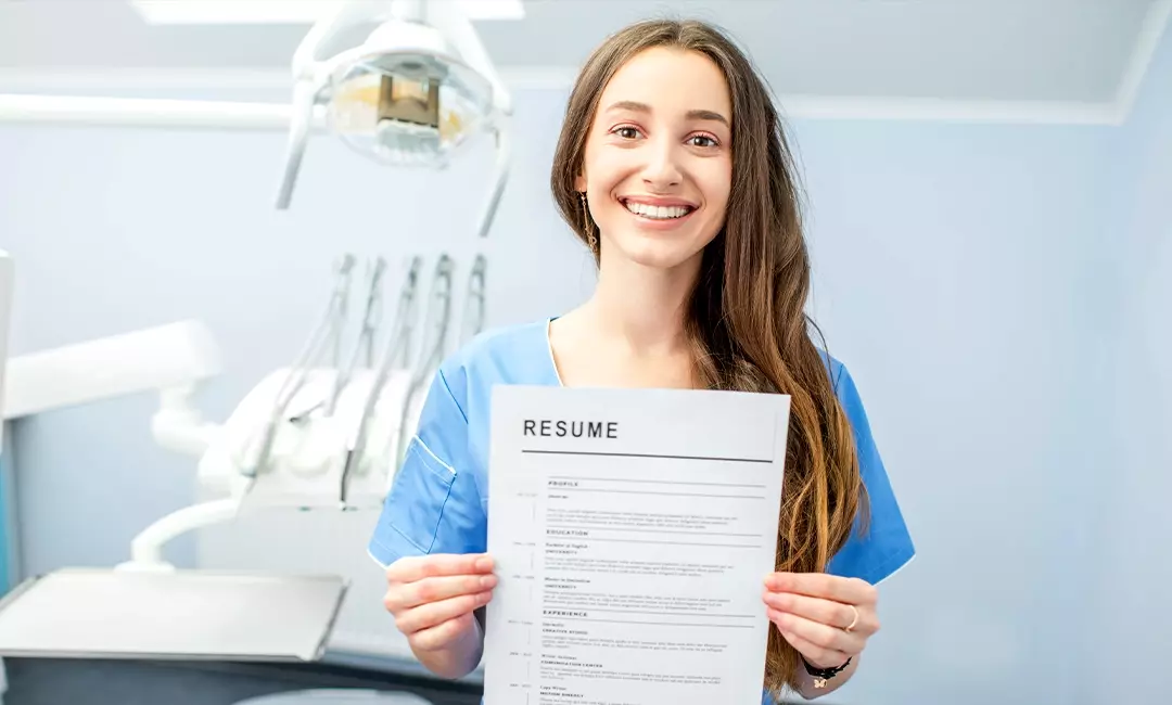 Dental assistant student holding her professionally designed resume